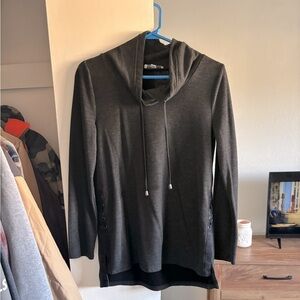 Long grey sweater with a high neck line that is flattering to all.